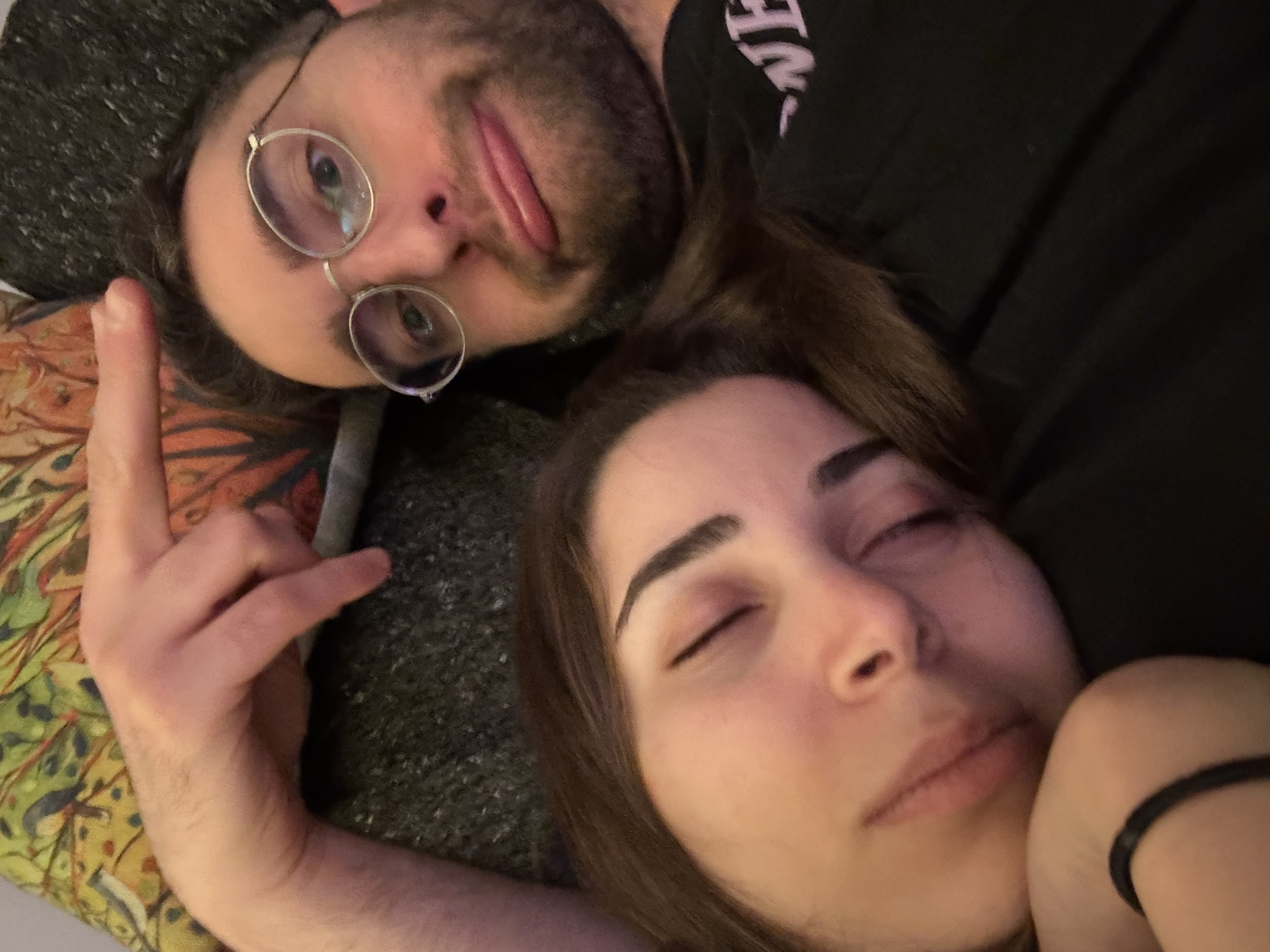 Couch selfie - Jad pointing at sleeping Reem