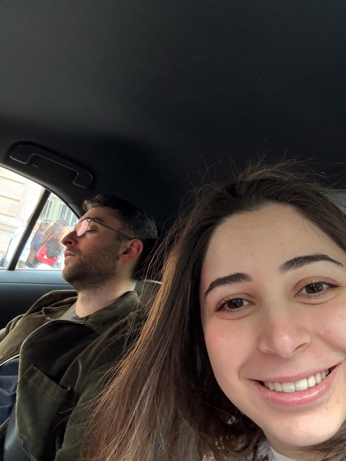 Car selfie - Reem grinning while Jad sleeps